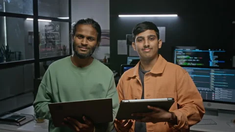 Portrait of Smiling Developers Holding Devices in Tech Office Stock Footage 348378415