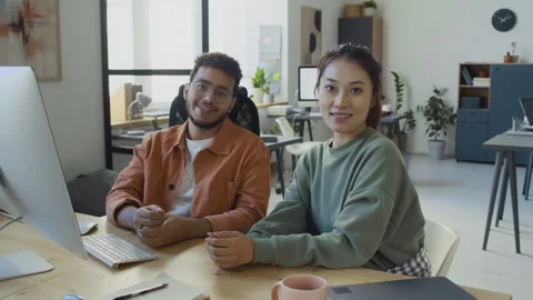 Portrait of Smiling Diverse Young IT Engineers Sitting by Computer in Office Stock Footage 293169422