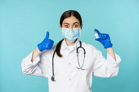 Portrait of smiling doctor, medical personel in face medical mask and rubber Stock Photos