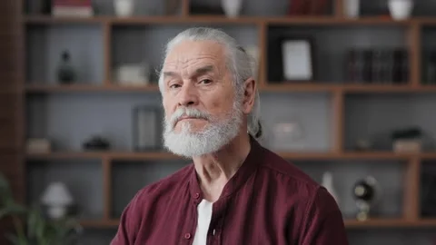 Portrait of smiling elderly gray-haired man looking at camera. Handsome senior Stock Footage 197140102