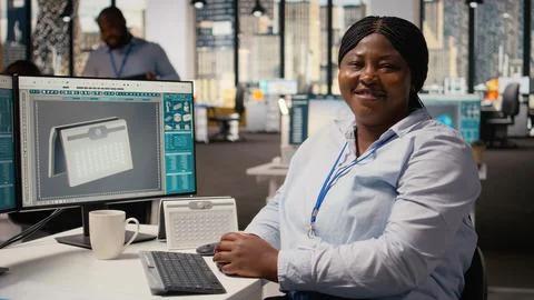 Portrait of smiling engineer using PC to create solar powered device design Stock Photos