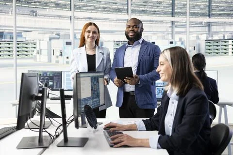 Portrait of smiling engineering team configuring PCB electronic hardware setups Stock Photos