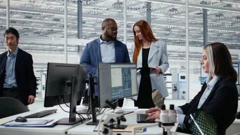 Portrait of smiling engineering team examining semiconductor substrate Stock Footage 335877948