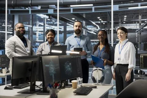 Portrait of smiling engineering team working in server farm, analyzing data Stock Photos