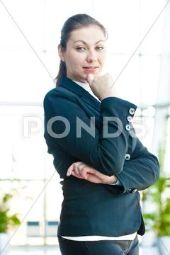 Portrait of a smiling girl on the background of the manager de-focus office Stock Photos