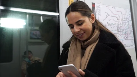 Portrait of smiling girl in train using smartphone chatting with friends woman Video stock 125848594