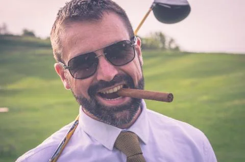 Portrait of smiling golfer with cigar with driver Stock Photos