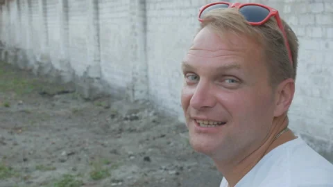 Portrait of a smiling handsome middle-aged man in red glasses Stock Footage 122097495