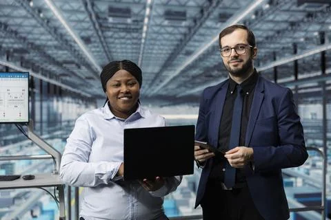 Portrait of smiling high tech microchip factory team of executives Stock Photos
