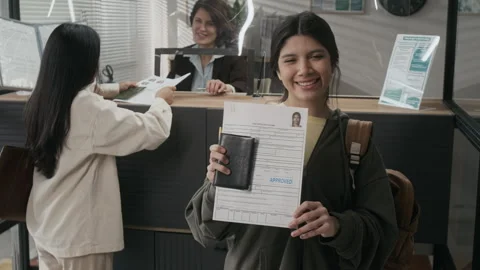 Portrait of Smiling Hispanic Girl Posing with Approved Visa Documents at Embassy Stock Footage 331508994