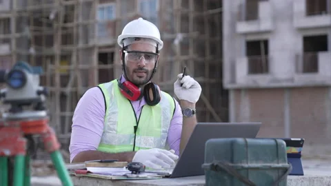 Portrait smiling Indian engineer standing with laptop look at camera. Vídeo Stock 161811422