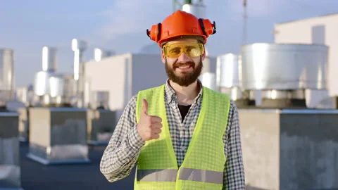 Portrait of a smiling large engineer man posing in front of the camera showing a Stock Footage 145211291