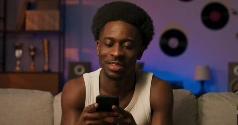 Portrait of a smiling man with afro in a white T-shirt with visible muscular 库存影片 200796464