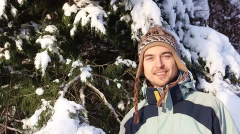 Portrait of a smiling man on a background of snowy winter spruce Stockbeeldmateriaal 46301225