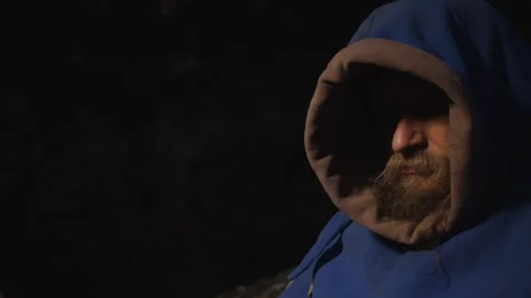 Portrait of a smiling man with a beard in a medieval costume with a hood on a Stock Footage 277724398