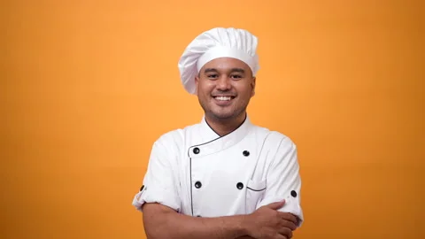 Portrait of smiling man chef standing and arms crossed on isolated yellow. Stock Footage 172283687