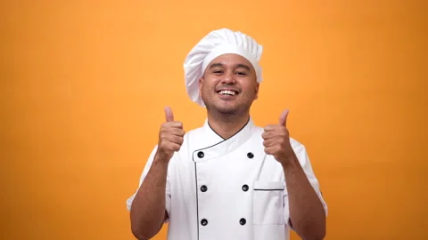 Portrait of smiling man chef standing and thumbs up on isolated yellow. Stock Footage 172283712