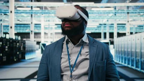 Portrait of smiling man in data center putting VR headset on Stock Footage 330139513