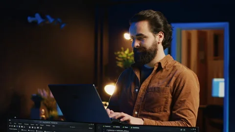 Portrait of smiling man doing IT support job from home, standing in office 動画素材 265342360