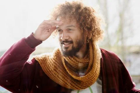 Portrait of smiling man with dyed ringlets looking into a windowpane Stock Photos