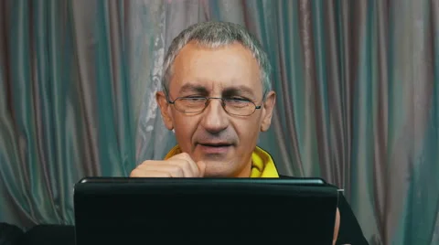 Portrait Smiling Man in Glasses Reading a Tablet Computer Stock Footage 47784846