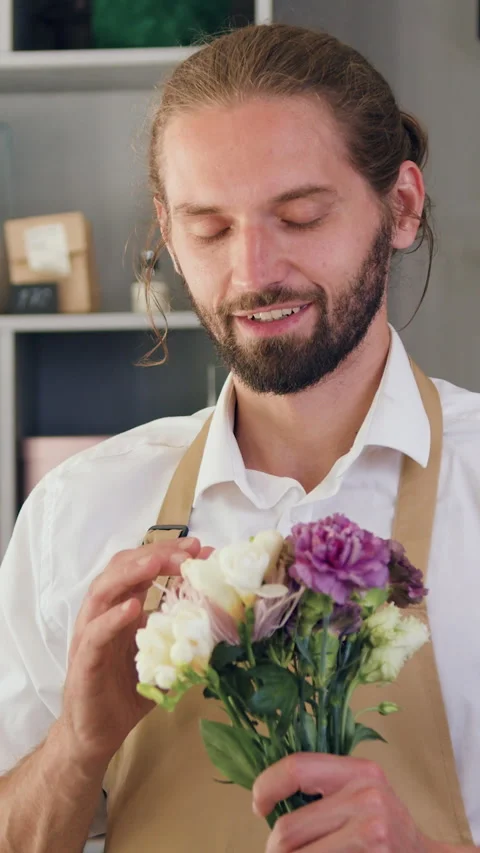 Portrait of smiling man looking at camera standing at workplace. Florist shop ow Stock Footage 329433034