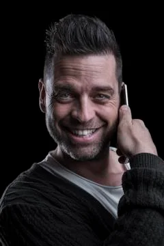 Portrait of a smiling man looking at the camera talking on the mobile Stock Photos