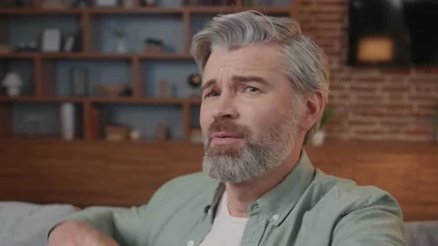 Portrait of smiling man making selfie or video call while sitting at home on Stock Footage 220202826