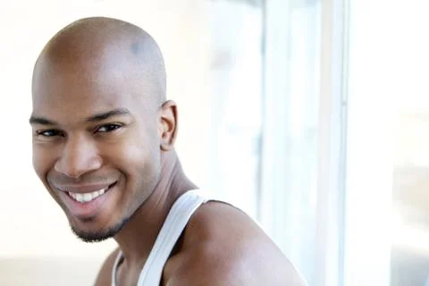 Portrait of a smiling man sitting by window Stock Photos