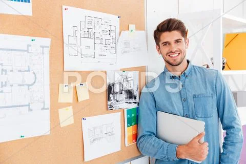 Portrait of a smiling man standing at the task board Stock Photos