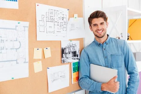 Portrait of a smiling man standing at the task board Stock Photos