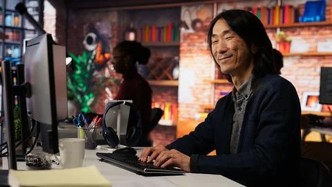 Portrait of smiling man using coding platform in Silicon Valley workplace 스톡 사진