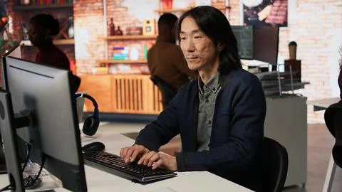 Portrait of smiling man using coding platform in Silicon Valley workplace 스톡 사진