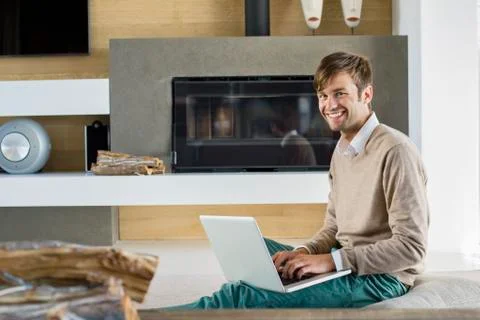 Portrait of a smiling man using a laptop Stock Photos