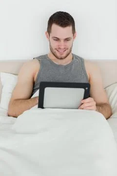 Portrait of a smiling man using a tablet computer Foto stock