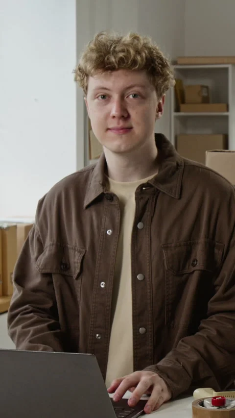 Portrait of Smiling Man Working on Laptop in E-commerce Warehouse Stock Footage 342601332