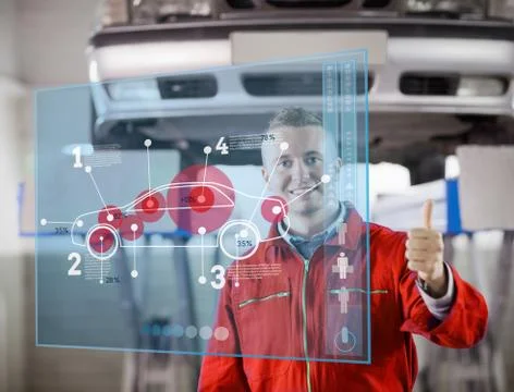 Portrait of smiling mechanic showing thumbs up with futurist interface Stock Photos