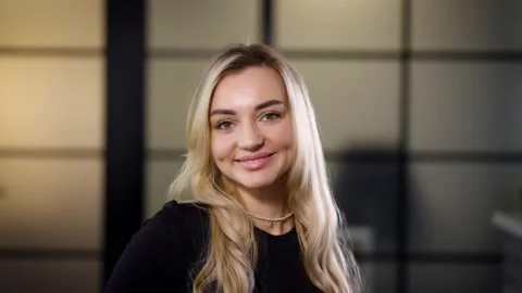 Portrait of a smiling middle-aged blonde woman with long hair indoors, a woman Stock Footage 236300650