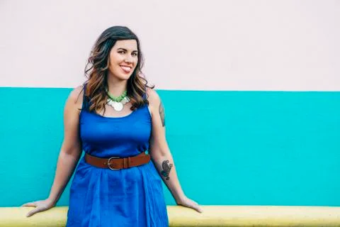 Portrait of smiling Mixed Race woman wearing blue dress Stock Photos