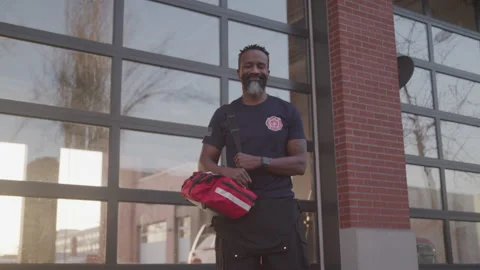 Portrait of a Smiling Paramedic in Front of the Fire Station Stock Footage 208782934