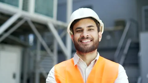 Portrait of smiling professional engineer wearing safety helmet and vest standin Stock Footage 314719989