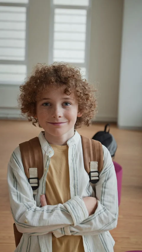 Portrait of Smiling Schoolboy Standing with Backpack in Classroom Stock Footage 345237483