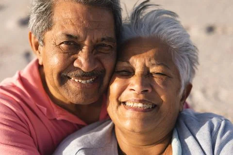 Portrait of smiling senior multiracial couple enjoying retirement together at Stock Photos