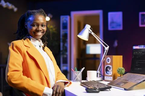Portrait of smiling software developer writing code on laptop screen Stock Photos