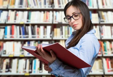 Portrait of a smiling student in a library Stock Photos