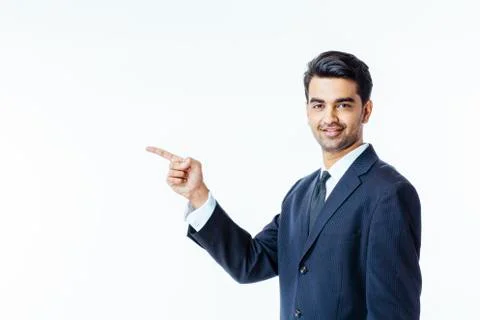 Portrait of a smiling, successful businessman in black suit and tie pointing  Stock Photos
