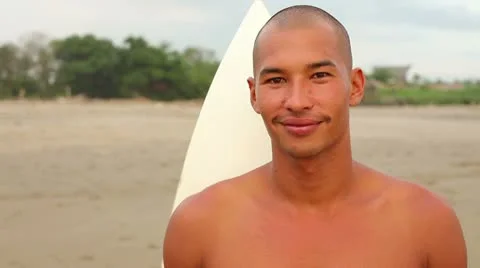 Portrait of smiling surfer on beach Stock Footage 10797576