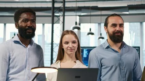 Portrait of smiling teamworking programmers utilizing AI to optimize performance Stock Photos