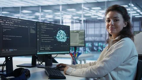 Portrait of smiling technician programming in AI data center Stockfoto's