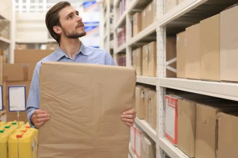 Portrait of a smiling warehouse keeper at work. Stock Photos